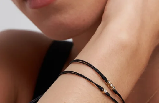 two diamond string bracelets on a wrist