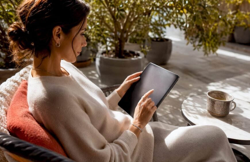 Woman browsing luxury string bracelets online in café